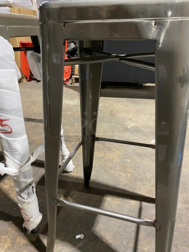 Brand new gunmetal grey industrial-style backless bar stool, stackable, commercial grade, pristine condition.