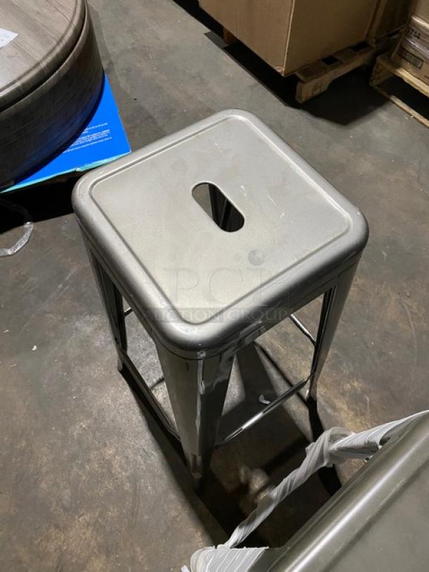 Brand new gunmetal grey backless industrial-style stackable bar stool, metal construction, commercial grade.