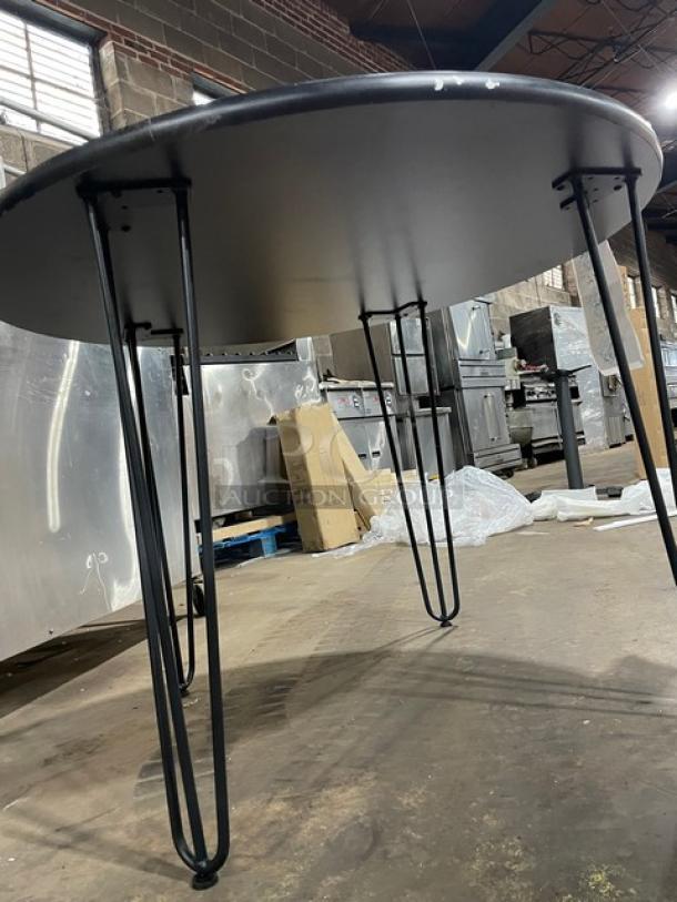 Brand new 40-inch round reversible mahogany/black bar-height dining table, Model R40, hairpin legs, pristine condition.