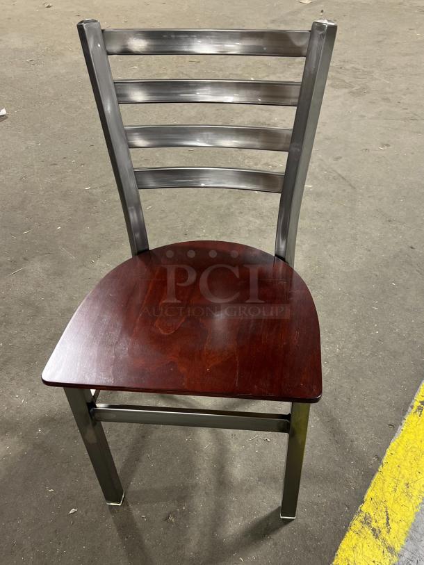 Brand new stackable metal dining chair frame with ladder-back style and mahogany wooden seat, commercial quality.