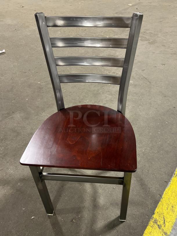 Brand new commercial metal ladder-back dining chair with stackable frame and mahogany wooden seat.