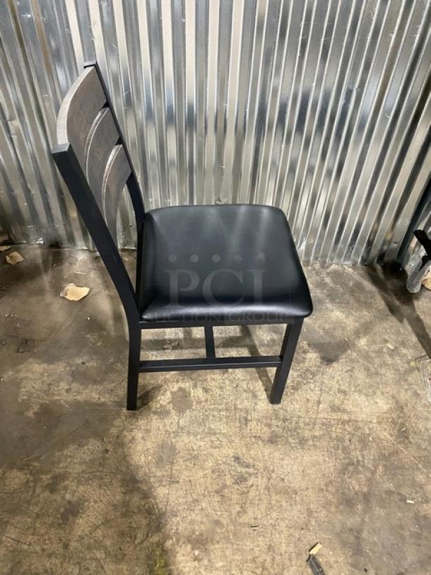 Brand new heavy-duty black metal slotted ladder back dining chair with cognac seat; pristine condition, set of four available.
