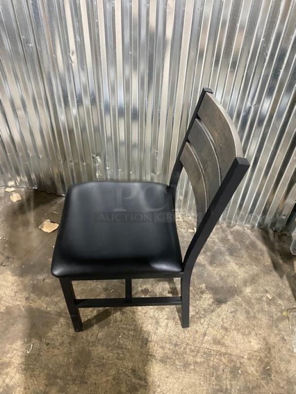 Brand new heavy-duty black metal slotted ladder back dining chair with cognac seat. Durable welded frame, pristine condition.