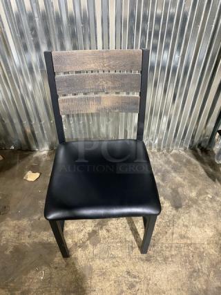 Brand new heavy-duty welded black metal slotted ladder back dining chair with cognac seat.