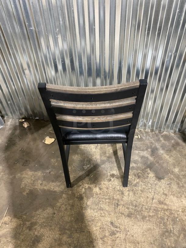 Brand new heavy-duty black metal slotted ladder-back dining chair with cognac seat. Durable welded construction.