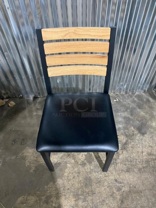 Brand new heavy-duty black metal dining chair with wooden slotted ladder back and black seat. Includes 4 chairs total.