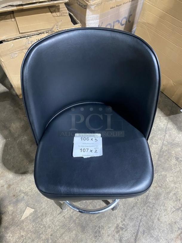 Brand new navy blue vinyl low-back round office chair with chrome legs, shown in warehouse. Tag with "106 x 3Y, 107 x Z" on seat.