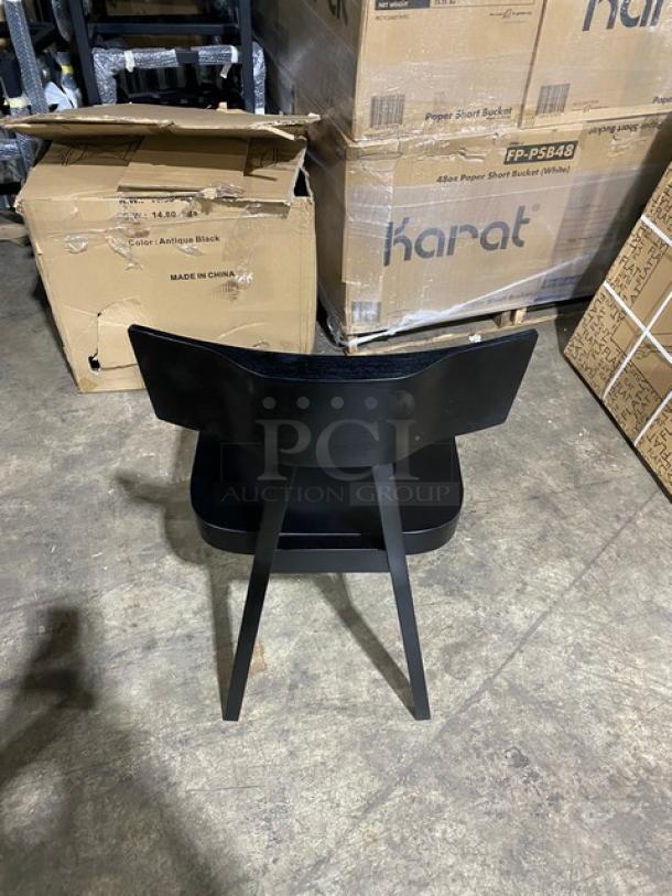 Brand new Toledo bar-height black bar stool, sleek design, in perfect condition, features sturdy wooden legs.