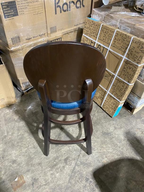 Brand new round-back bar stool with solid wood-style finish and blue upholstered seat. Ready-to-assemble. Mint condition.