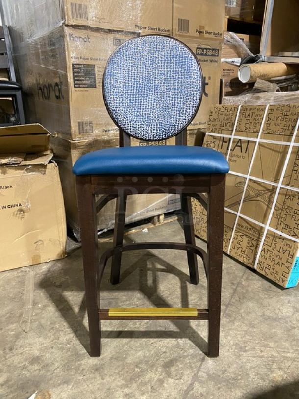 Brand new solid wood-style bar stool with round-back design, blue upholstered seat. Excellent condition.