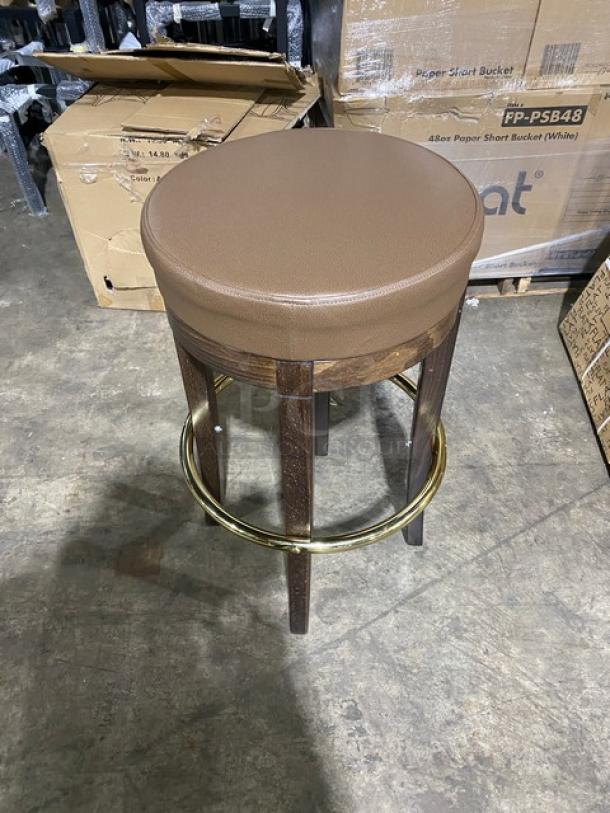 Brand new mid-century modern swivel bar stool with brass finish and tan upholstered seat.