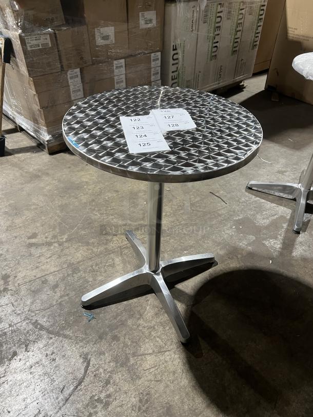 Commercial round bistro table, aluminum finish, lattice design. Indoor/outdoor use, excellent condition. Tags with numbers visible.