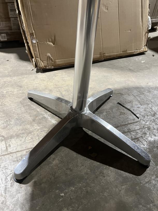 Commercial round dining table with mahogany top, metal pedestal base, good condition. Ideal for restaurant or cafe use.