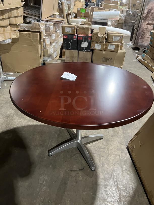 Round mahogany dining table with metal pedestal base, commercial quality, excellent condition, ideal for restaurants.