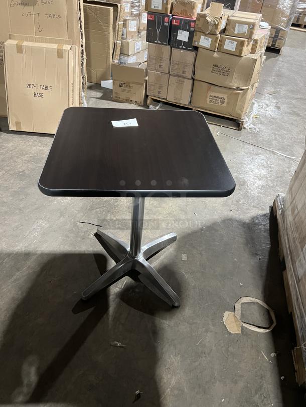 Commercial black square dining table with stainless steel pedestal base, modern style, suitable for indoor/outdoor use.