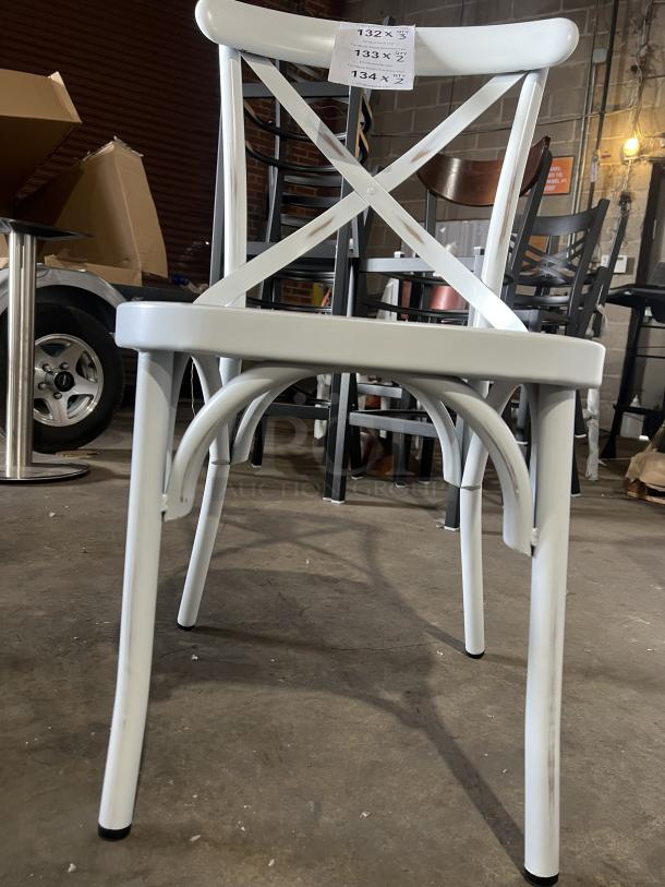 Commercial white cross-back stackable dining chair, sturdy construction, excellent condition, labels with quantities visible.