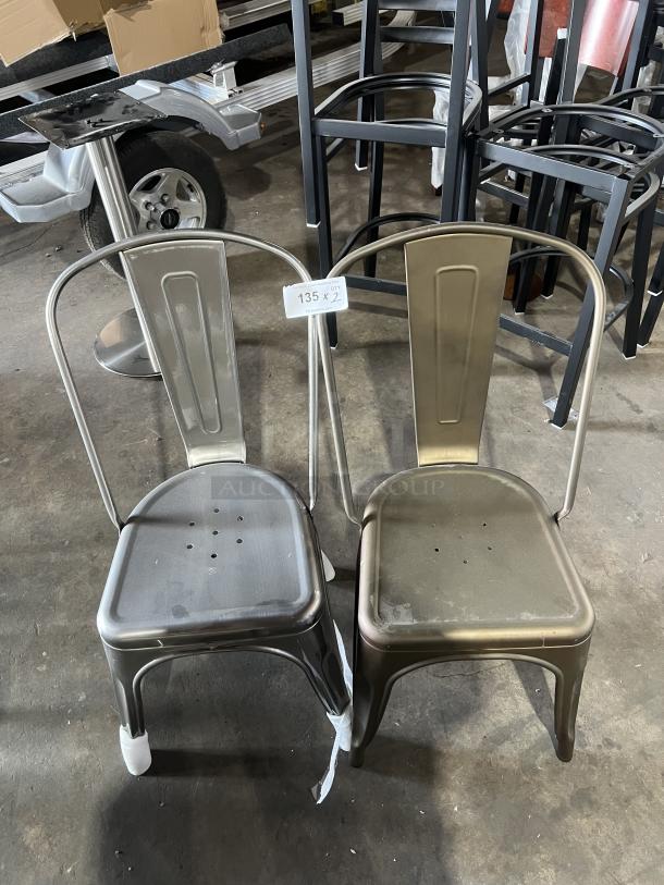 Industrial Tolix-style stackable dining chairs, two metal finishes, commercial-grade, showing minimal wear, labeled "135 x 2."
