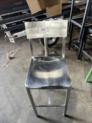 Commercial aluminum industrial-style bar stool with sculpted seat, curved backrest. Condition: excellent, marked "139".