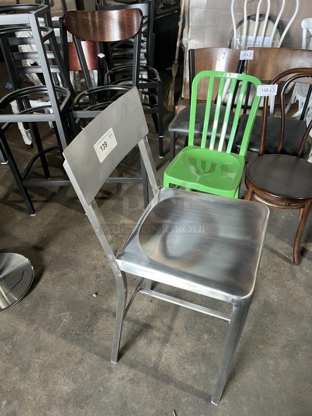 Commercial aluminum bar stool with sculpted seat, curved backrest, and industrial style; item tag reads "139".