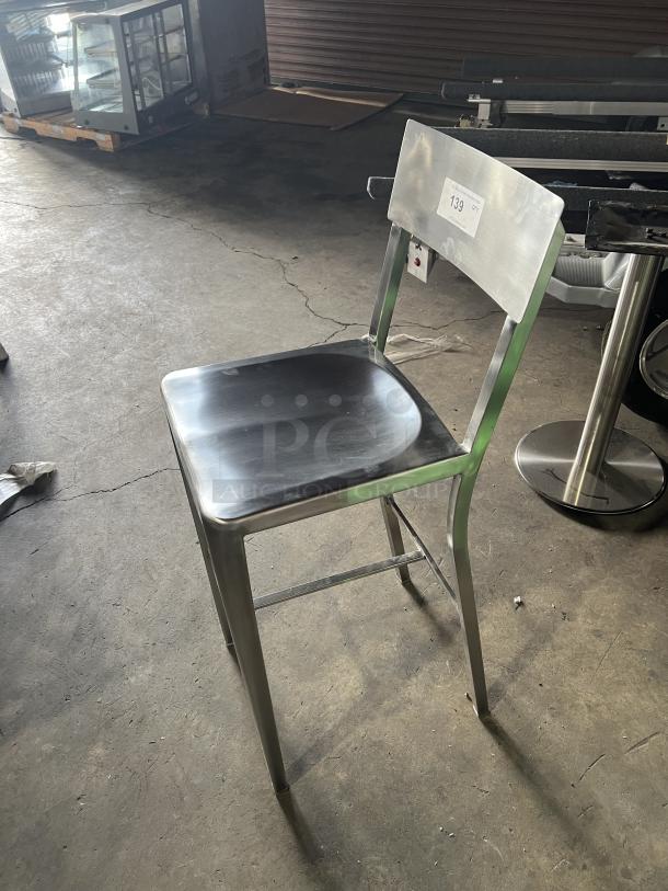 Commercial aluminum bar stool with sculpted seat and curved backrest, industrial style, good condition, auction lot 139.