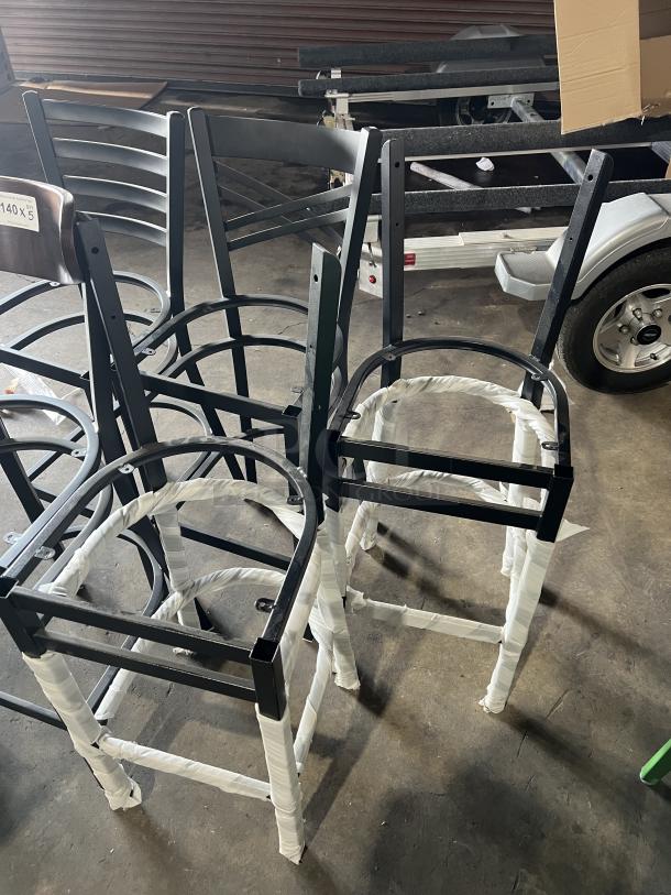 Brand new, assorted dining chairs. Black metal frames, wrapped in protective material. Ideal for buyers seeking modern seating options.