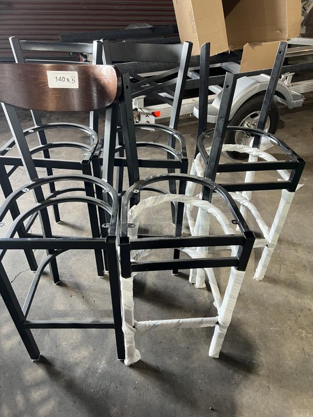 Brand new miscellaneous dining chairs, metal frames, wooden backrest. Label indicates "140 x 5 qty".