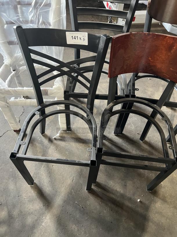 Brand new miscellaneous dining chair frames, black metal, various styles. Tag indicates quantity: five pieces, lot 141.