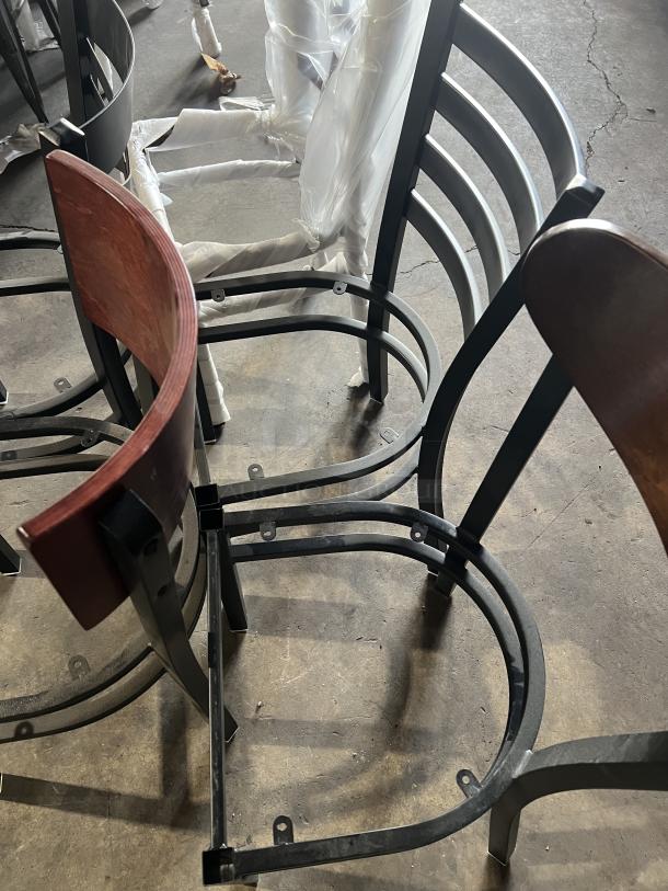 Brand new miscellaneous dining chairs with metal frames and plastic-wrapped seats. Variety of wood backrests.