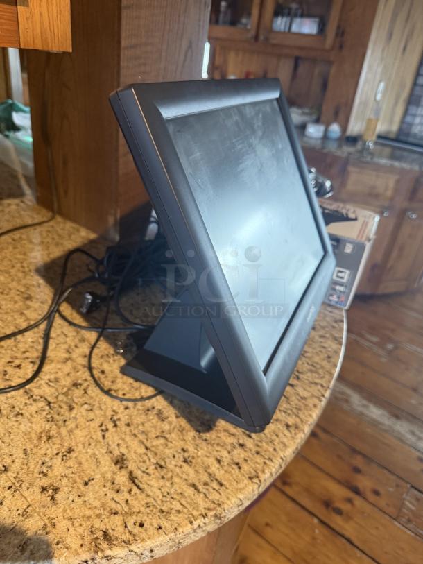 Pinnacle POS system in good condition, with a sleek black screen and sturdy stand; ideal for retail settings.