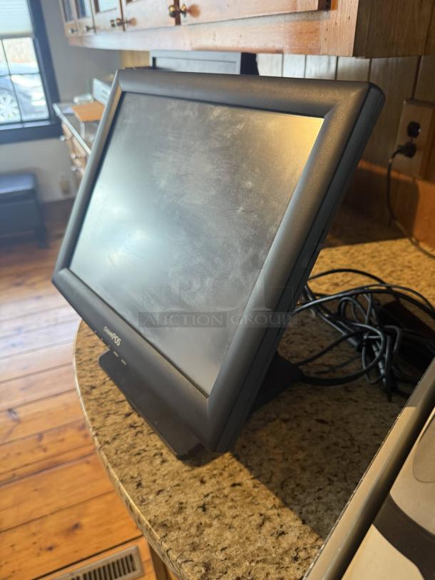 Pinnacle POS system with screen and cables on a countertop, designed for retail efficiency. Clean condition.