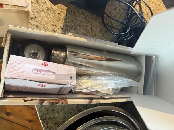 iSi Thermo Xpress Whip 1L in box, includes cream charger and accessories, stainless steel, ideal for foams and creams.