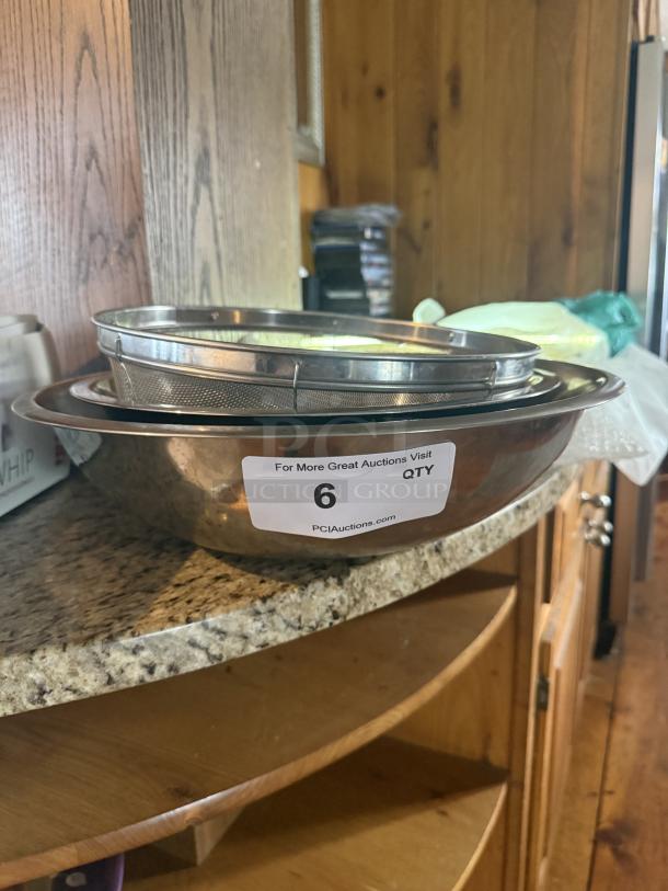Commercial-grade 16" stainless steel mixing and sifting set on counter, includes bowls and mesh sifter, label with auction info.