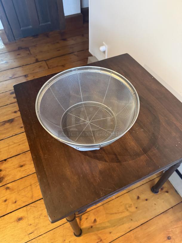 Commercial 12" stainless steel strainer with wire mesh, ideal for large-volume prep. Durable, heavy-duty, excellent condition.