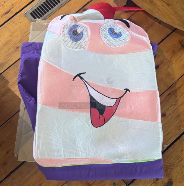 Vibrant cow mascot costume, soft-serve design with pink stripes, purple and green base, cheerful face, red straw, bright cherry.