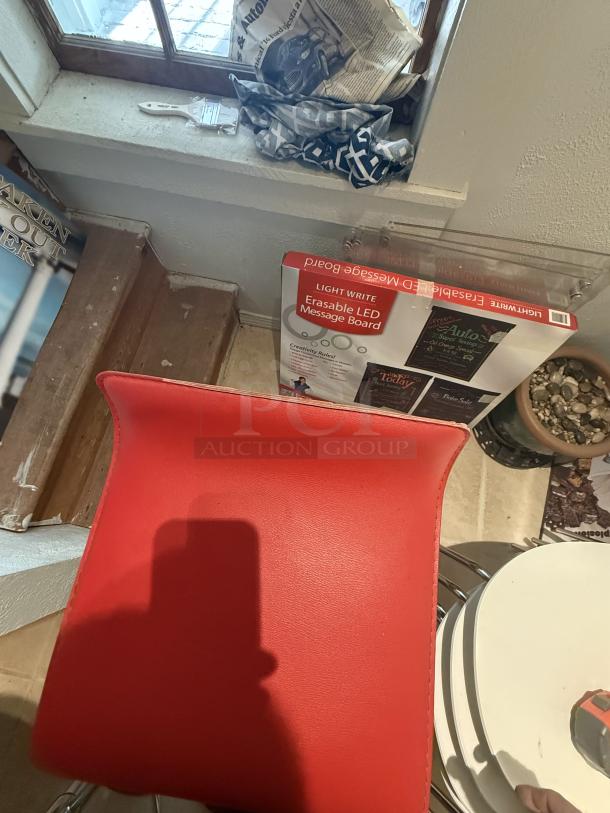 Red bar stool with minor tear, 29" counter height, adjustable swivel. Modern design, ideal for cafes and display areas.