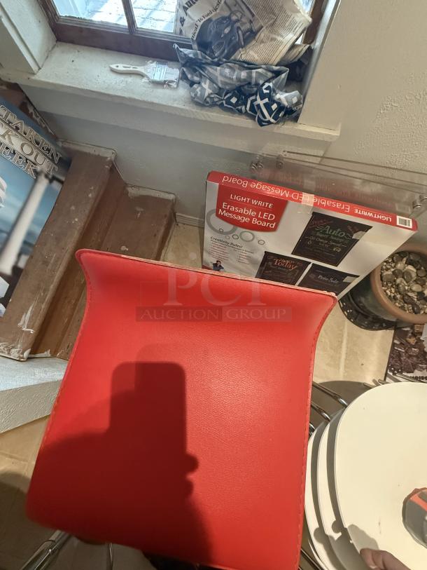 Red bar stool with minor tear, 29" counter height, swivel feature. Ideal for breakrooms or cafes. Bright, modern design.