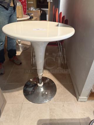 Set of 5 adjustable hydraulic bistro tables with white tops, chrome bases. Features height adjustment. Modern and durable design.