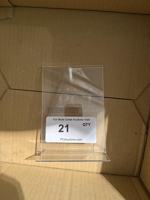 Set of six 5"x7" clear acrylic sign holders, L-shape, perfect for menus or photos. Features visible: "For More Great Auctions Visit PCIAuctions.com" tag.