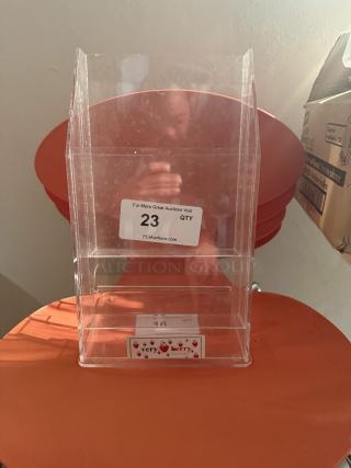 Clear 4-tier acrylic pamphlet holder for tri-fold brochures, holds 75 per pocket, sturdy, space-saving, minor wear.