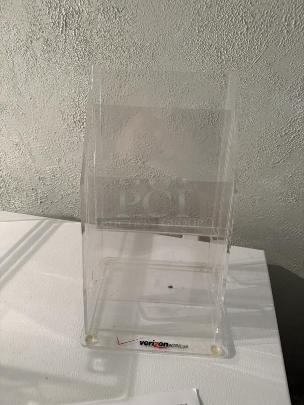 4-tier clear acrylic pamphlet holder for tri-fold brochures, 4" x 9", sturdy design with Verizon Wireless logo, holds 75 brochures per pocket.