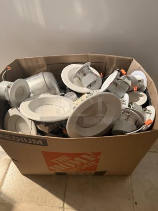 13 LED recessed light fixtures in a box, mix of flat discs and integrated styles, good used condition, orange quick-connect wiring.