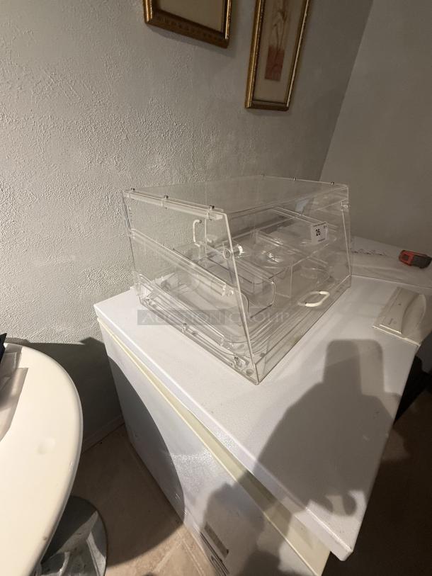 Clear acrylic countertop display case with removable dividers, 21" wide, showcasing sturdy transparent construction for retail use.