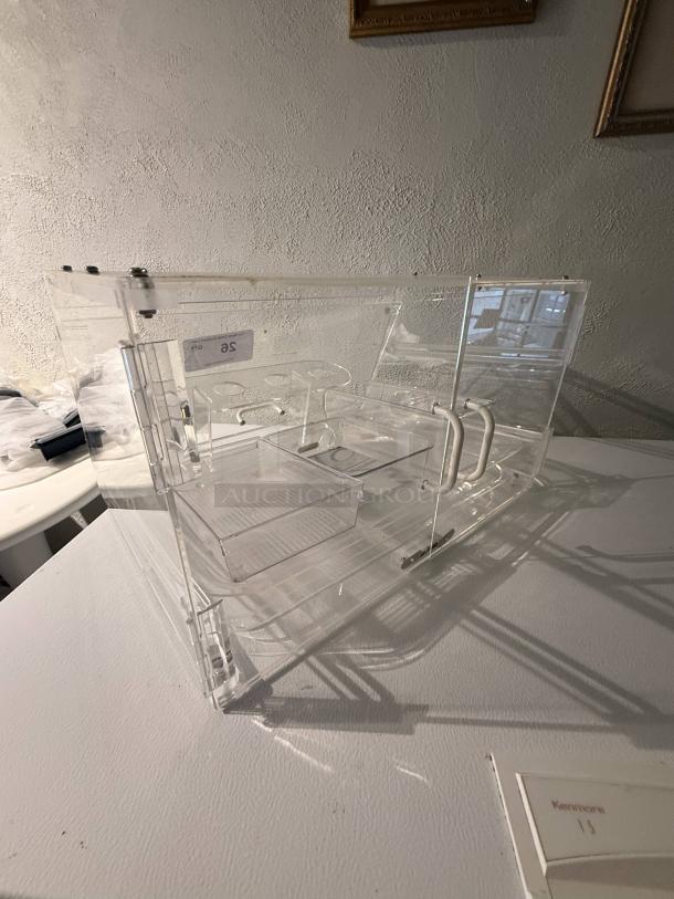 Clear acrylic countertop display case, 21" wide, transparent with removable dividers. Ideal for retail, showcasing items.