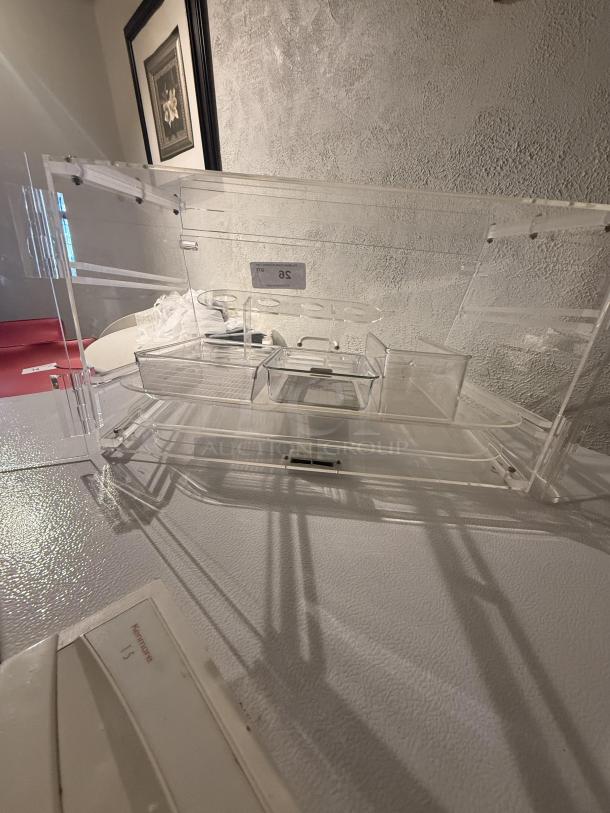 Clear acrylic countertop display case, 21" wide, with removable dividers, ideal for retail, showcasing items visibly and protected.