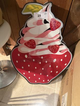 LED sign shaped like a strawberry sundae with whipped cream and strawberry slices; auction tag number 29 visible.