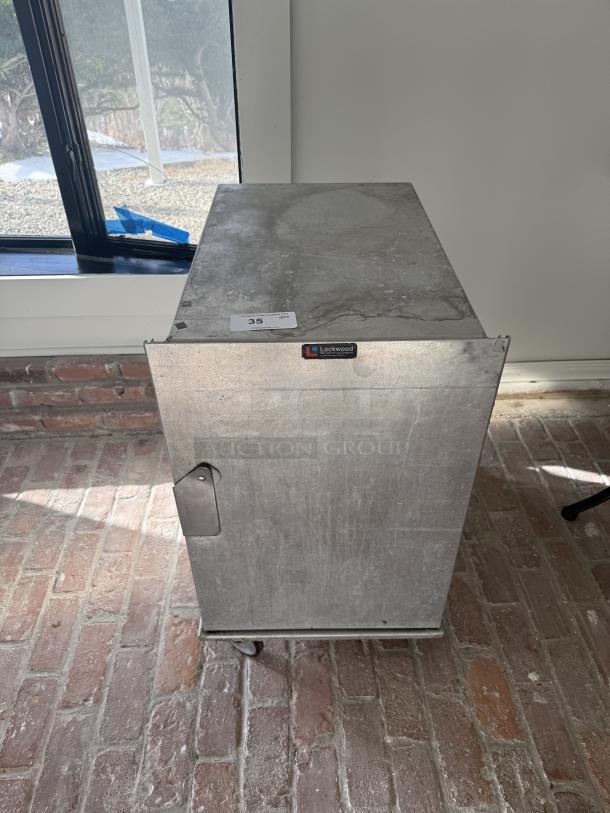 Lockwood mobile half-size pan rack, commercial grade, sturdy metal, on casters. Suitable for food transport and storage.