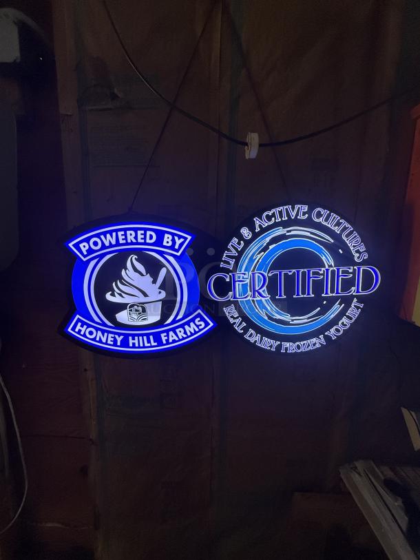 Bright blue and white LED signs for frozen yogurt shop, featuring "Powered by Honey Hill Farms" and "Certified Real Dairy Frozen Yogurt."