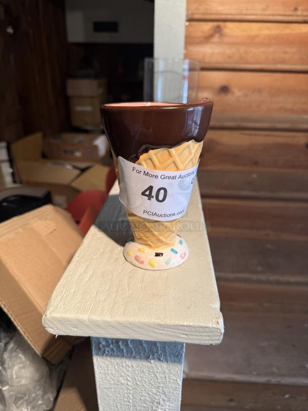 Ceramic ice cream cone mug used as pen holder, waffle cone design, sprinkles base, auction tag with number 40, sturdy condition.