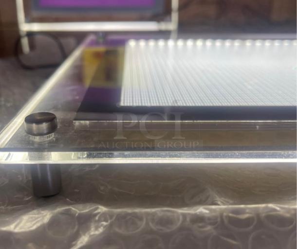 LED Light Up Erasable Message Board with edge-lit backlighting, sleek acrylic design, standoff mounting hardware visible.
