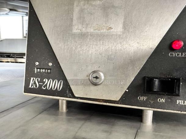 Ecolab ES-2000 commercial conveyor dishmachine, excellent condition, showing control panel with cycle and power switches.